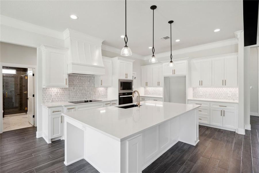 Kitchen with oven, stainless steel microwave, and tasteful backsplash