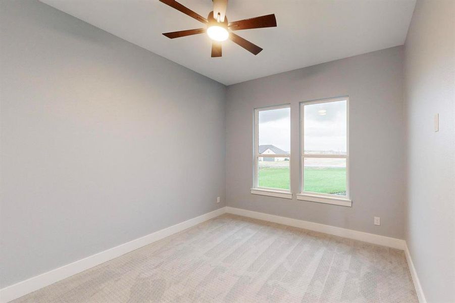 Unfurnished room featuring light carpet and ceiling fan