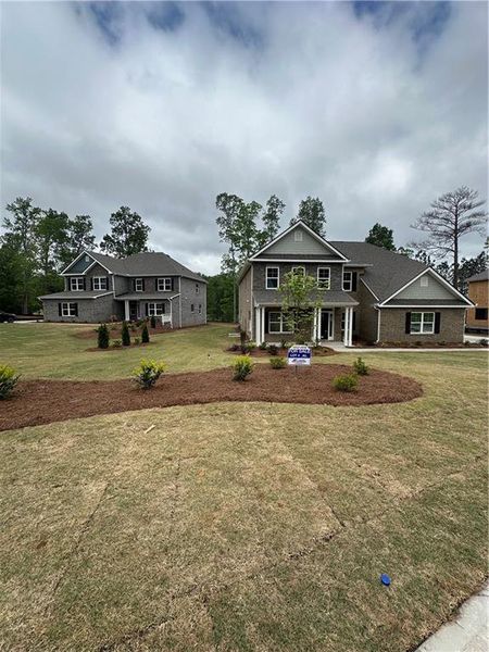 Front exterior of a new home in Mirror Lake at South Harbour, Villa Rica, GA, highlighting curb appeal (Image 16).
