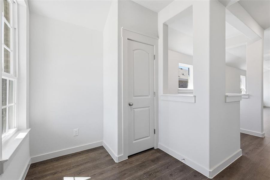 Corridor featuring dark wood-style floors