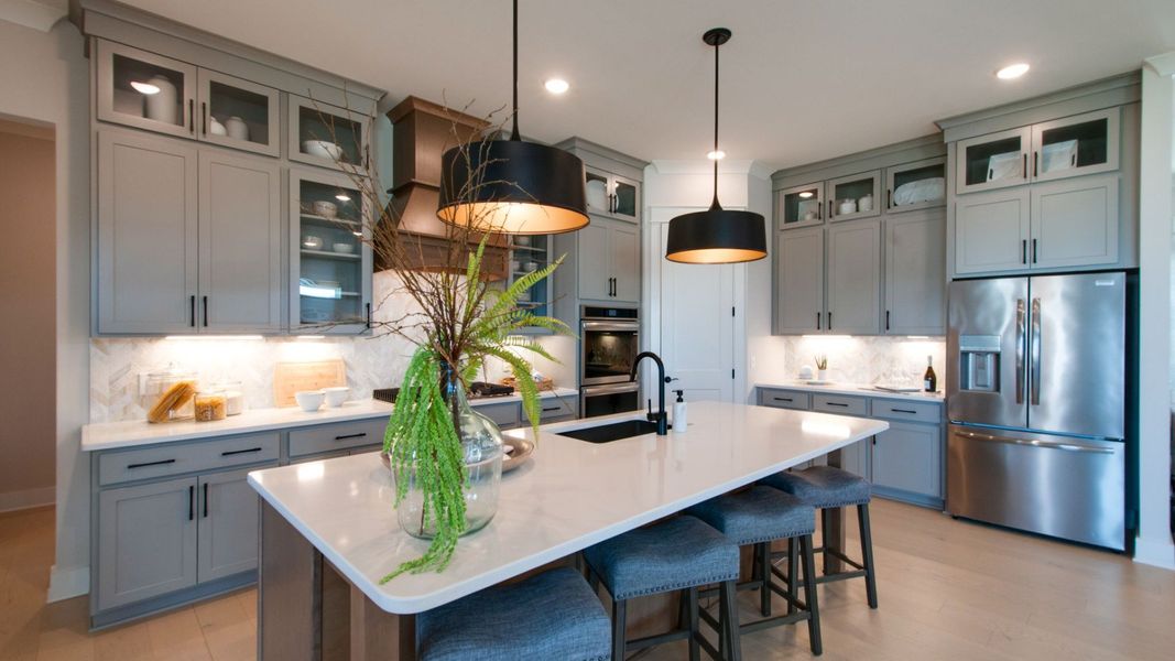 Kitchen with upgraded appliances and modern floor-to-ceiling cabinets Kitchen with upgraded appliances and modern floor-to-ceiling cabinets