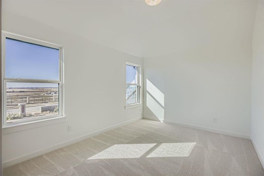 Unfurnished room featuring light carpet