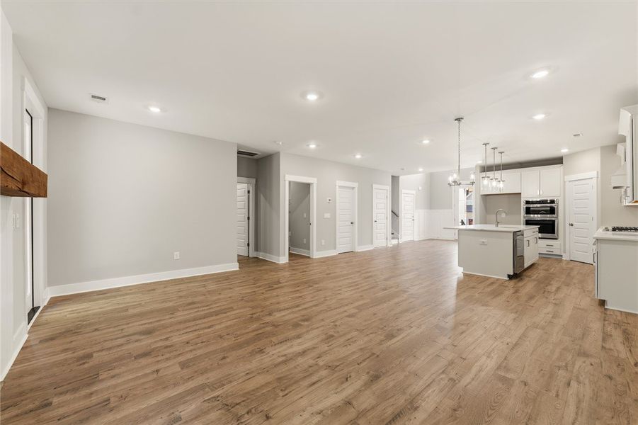 An open-concept living space with polished wood fl