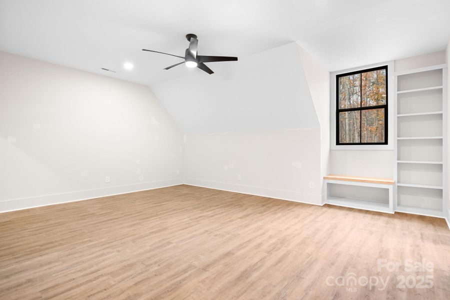These oversized bedrooms offer enough space for a full bedroom suite plus a cozy lounge area. Built in shelving and a charming bench seat add character and practicle storage. Connected by a stylish jack-and-jill bathroom, the space features a gorgeous dual sink vanity and separate shower room. This space would function as a second primary suite, too!