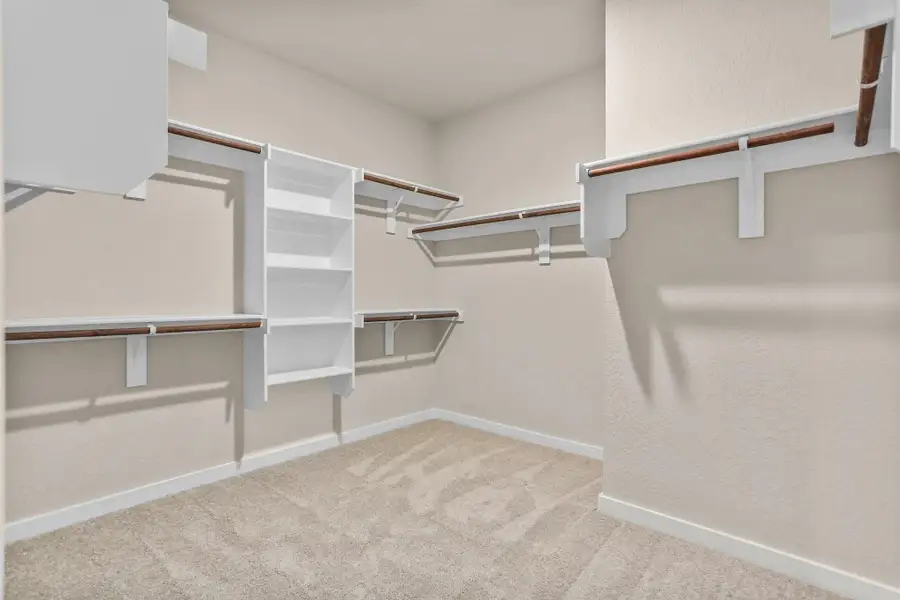 A stylish walk-in closet awaits, providing ample storage for your wardrobe and a little extra room for those cherished items. A stylish walk-in closet awaits, providing ample storage for your wardrobe and a little extra room for those cherished items.