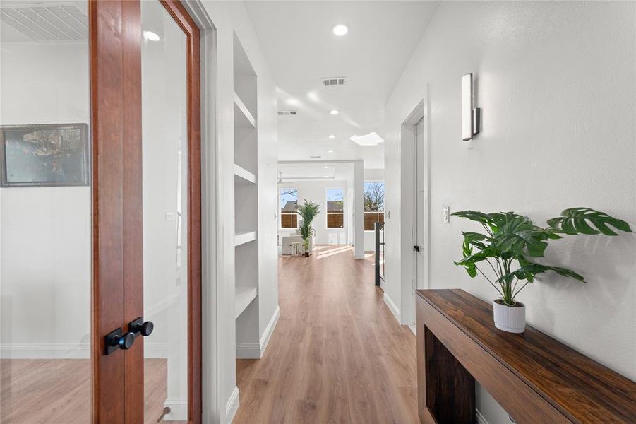 Hallway featuring light wood-style flooring and recessed lighting