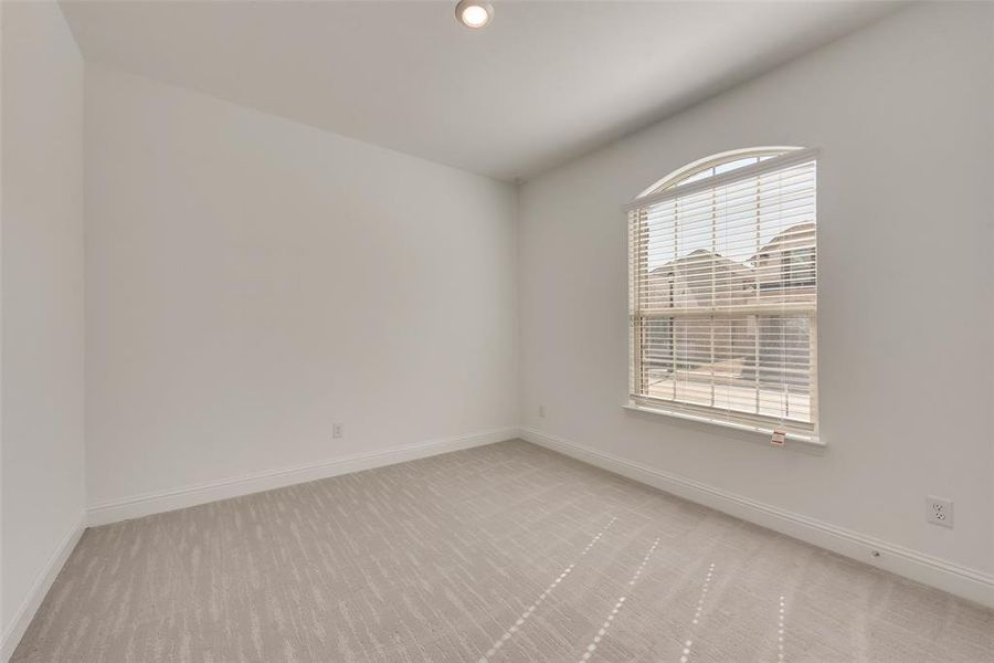 Empty room featuring light carpet and plenty of natural light