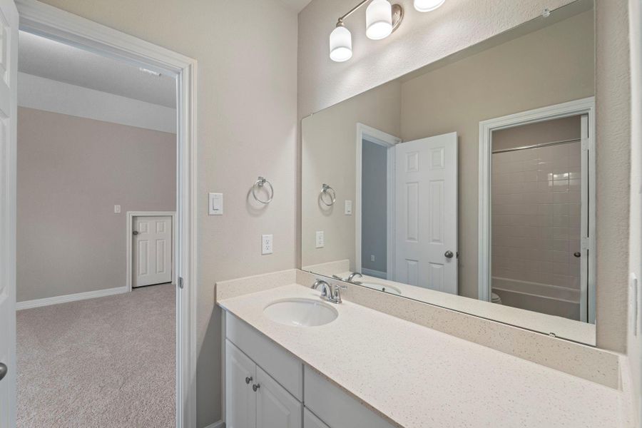 The secondary bath features tile flooring, white cabinetry and light countertops and a shower/tub combo. Perfect for accommodating any visiting family and friends. The secondary bath features tile flooring, white cabinetry and light countertops and a shower/tub combo. Perfect for accommodating any visiting family and friends.