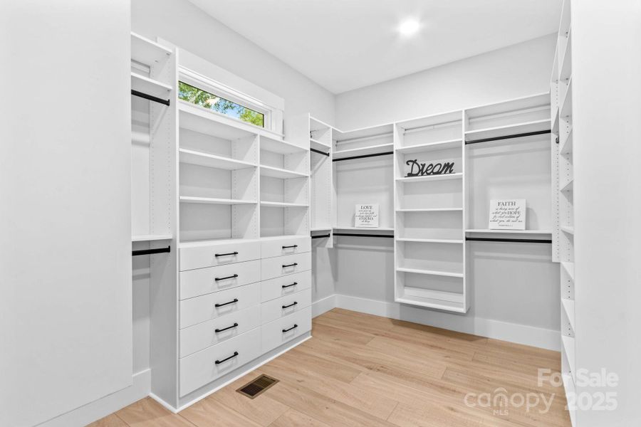 Main closet needs 3 photos to show custom organizers & how large it is with three sections.