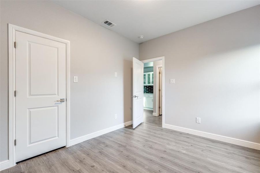 Unfurnished room with light hardwood / wood-style flooring