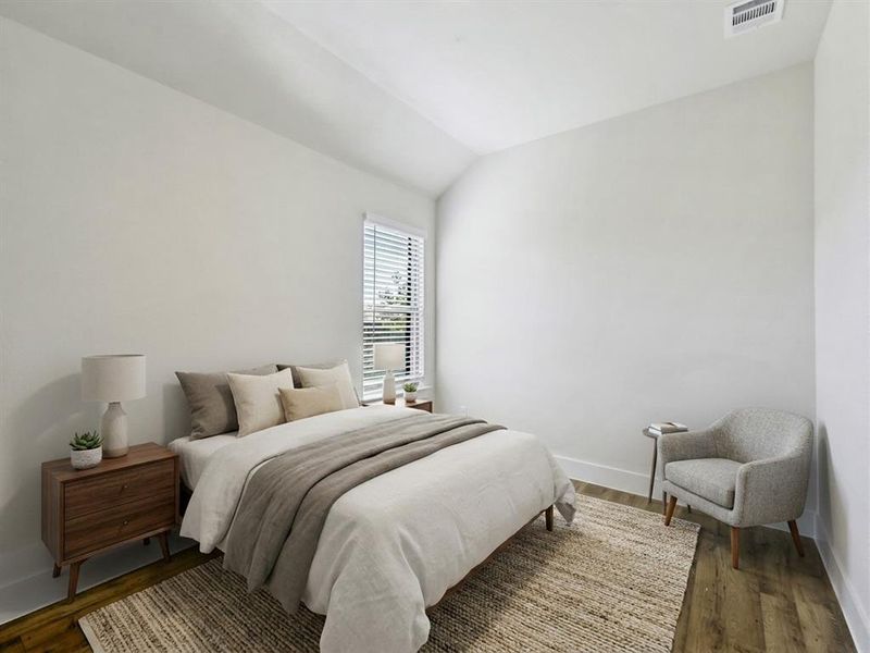White walls and wood-finish flooring define this bright room with a single window featuring horizontal blinds