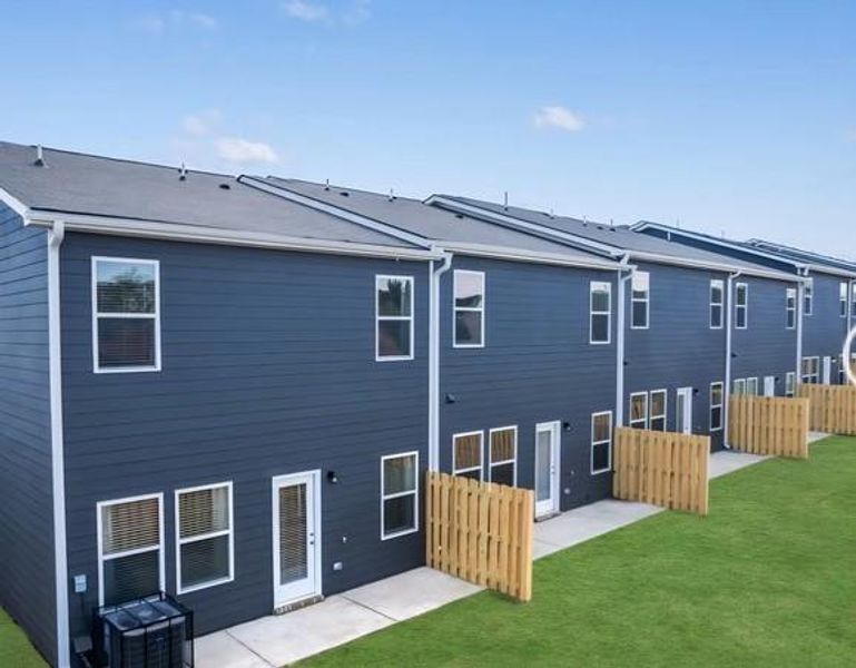 Exterior details and patio area of a home in The Enclave Townhomes, Hampton (Image 3).