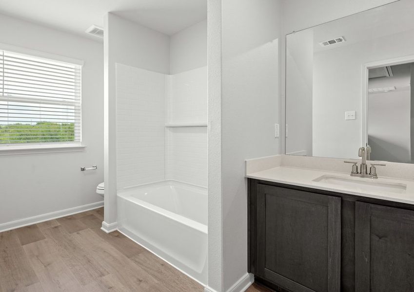 The secondary bathroom of the Cypress has a large vanity and shower-tub combo. The secondary bathroom of the Cypress has a large vanity and shower-tub combo.