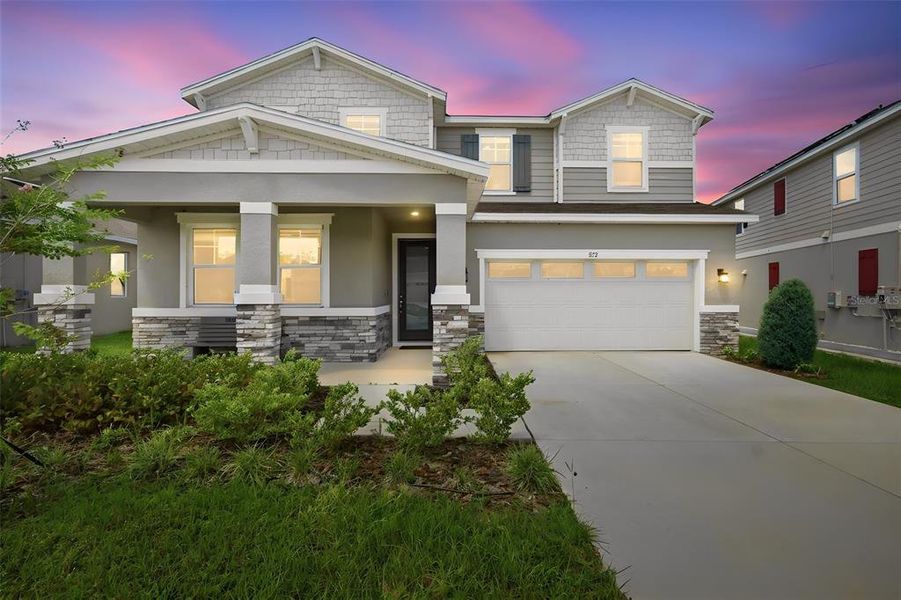 Front exterior of a new home in Seasons at Eden Hills, Lake Alfred, FL, highlighting curb appeal (Image 24). Front exterior of a new home in Seasons at Eden Hills, Lake Alfred, FL, highlighting curb appeal (Image 24).