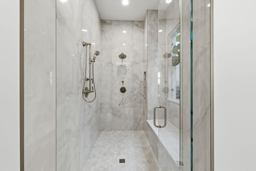 Bathroom featuring a marble finish shower and recessed lighting