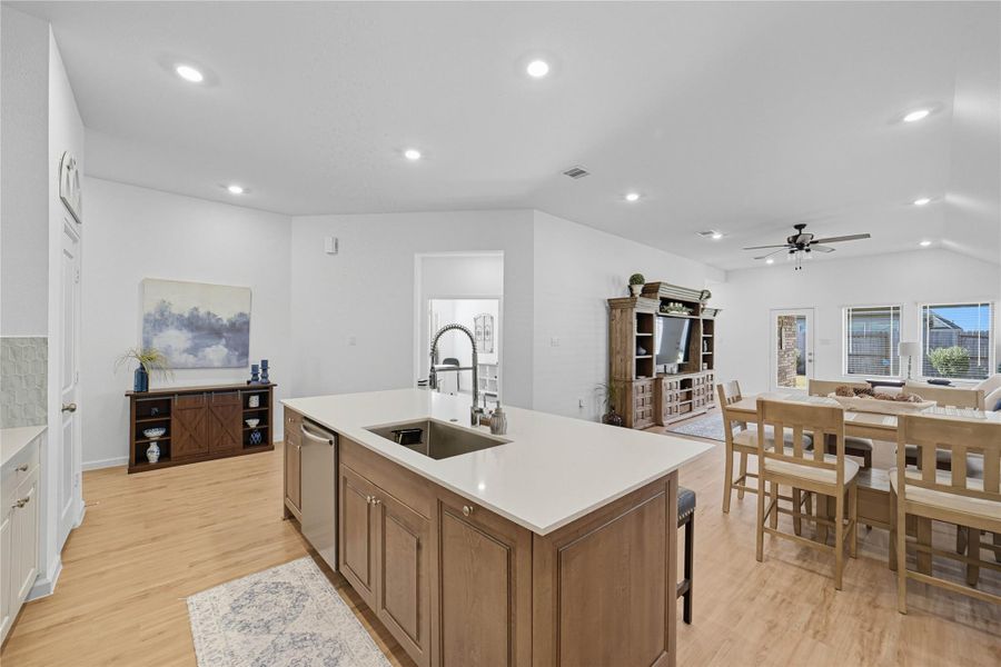 The modern kitchen features the sink in the island, overlooking the breakfast area and family room. The modern kitchen features the sink in the island, overlooking the breakfast area and family room.