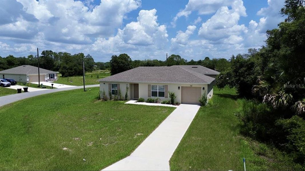Front exterior of a new home in Poinciana, Poinciana, FL, highlighting curb appeal (Image 1). Front exterior of a new home in Poinciana, Poinciana, FL, highlighting curb appeal (Image 1).