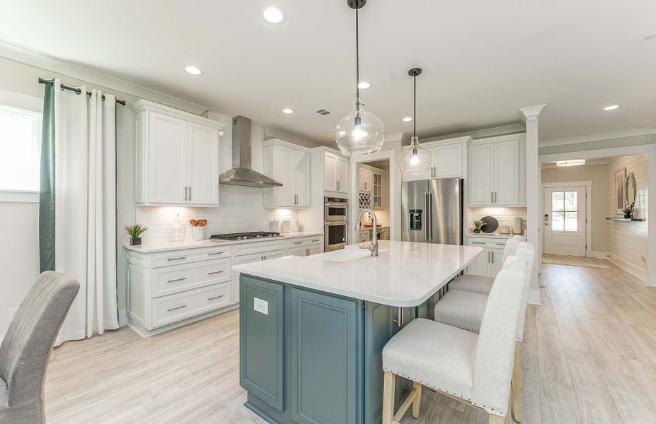 Luxurious Kitchen with Stainless Steel Appliances and Tile Backplash