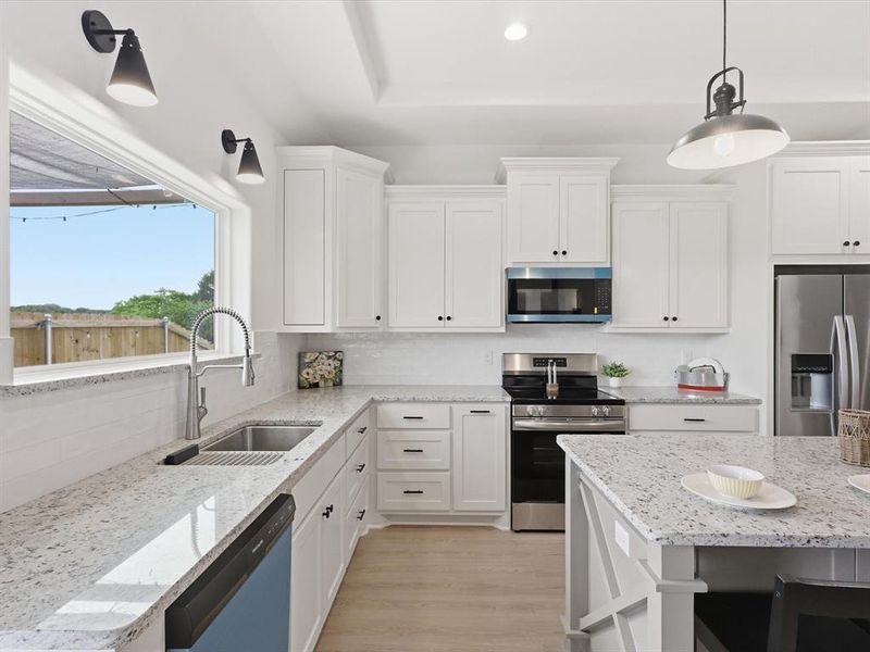 Natural light floods into this kitchen with the oversized window above the sink!