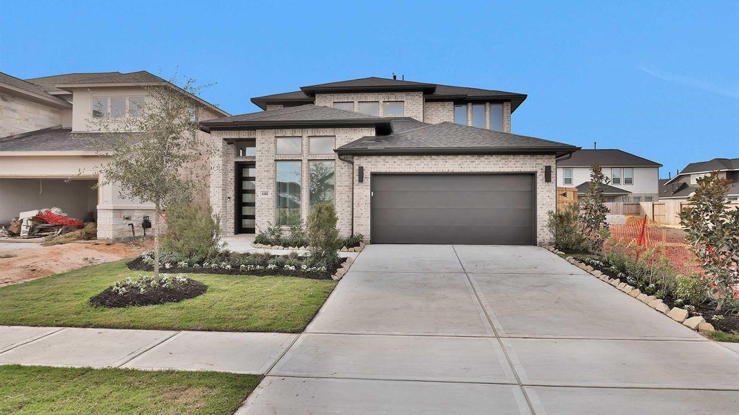 Front exterior of a new home in Cross Creek West 45', Fulshear, TX, highlighting curb appeal (Image 12). Front exterior of a new home in Cross Creek West 45', Fulshear, TX, highlighting curb appeal (Image 12).