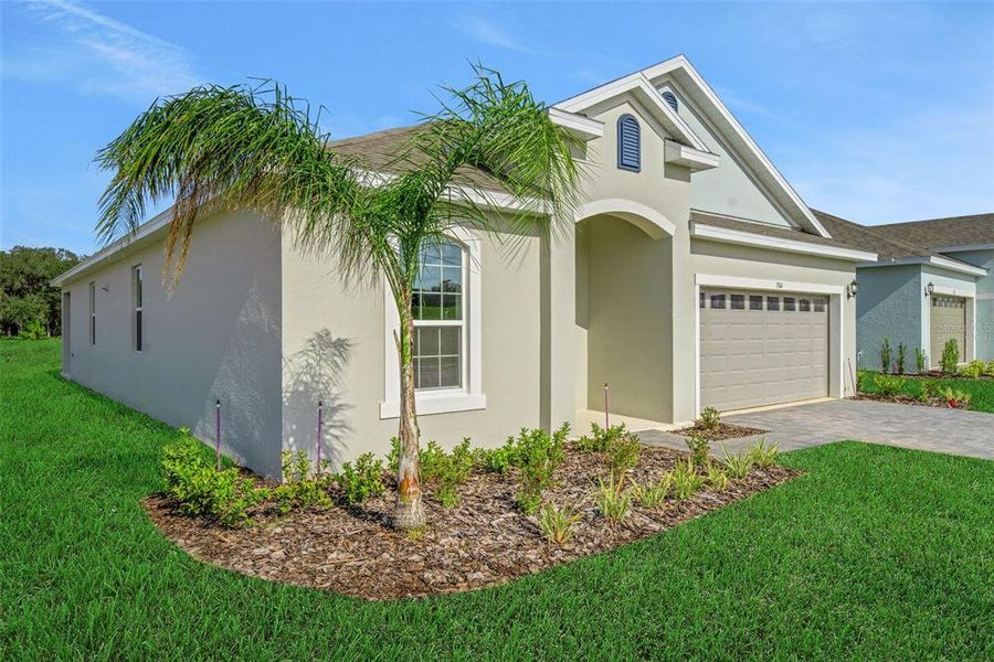 Front exterior of a new home in Reserve at Hammock Oaks, Lady Lake, FL, highlighting curb appeal (Image 2).