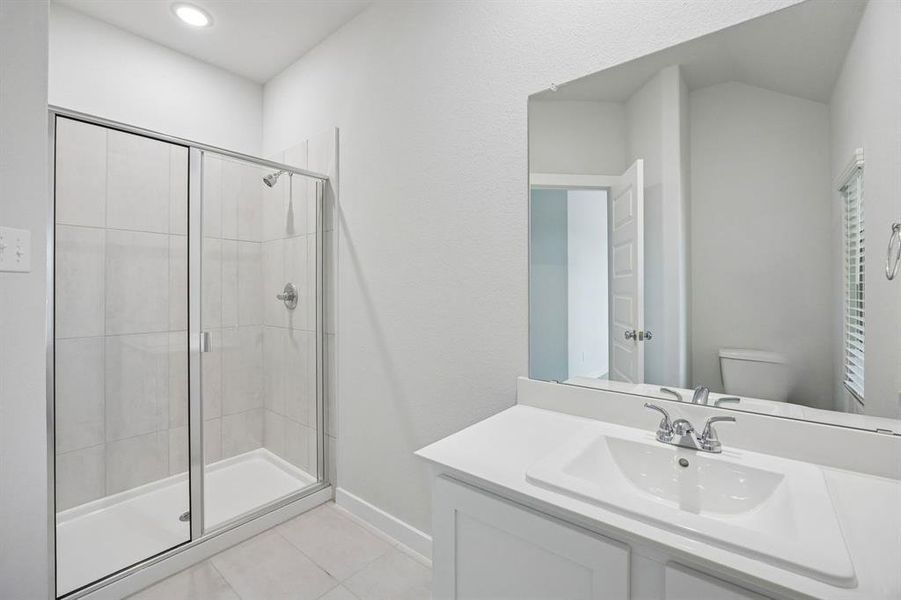 Bathroom in the Masters home plan by Trophy Signature Homes – REPRESENTATIVE PHOTO