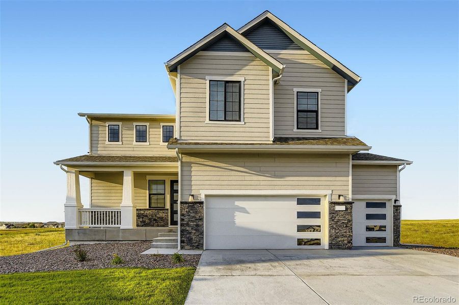 Front exterior of a new home in Spring Valley Ranch, Elizabeth, CO, highlighting curb appeal (Image 14).