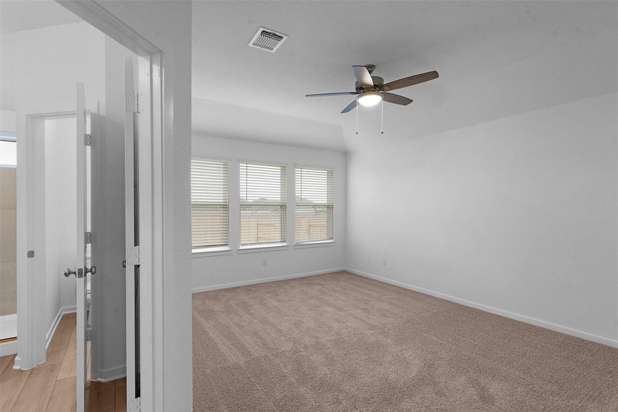 Spare room with healthy amount of natural light and ceiling fan Spare room with healthy amount of natural light and ceiling fan