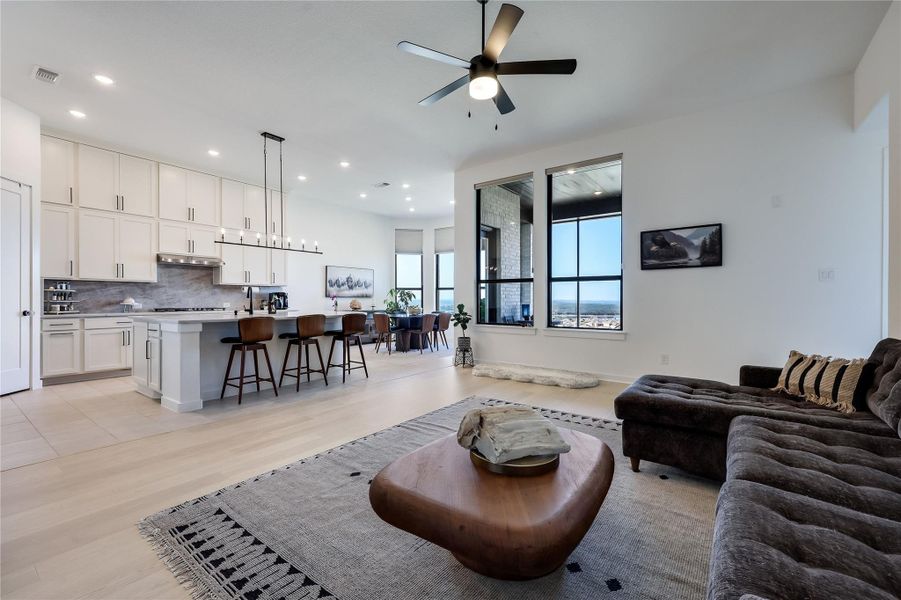 An open floorplan design seamlessly connects the living space to a modern kitchen. An open floorplan design seamlessly connects the living space to a modern kitchen.