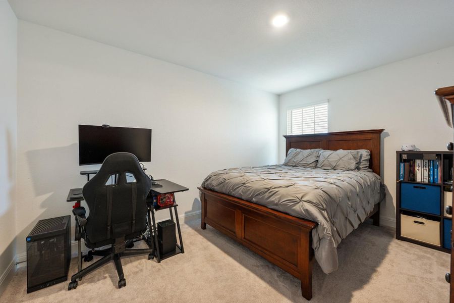 A well-lit bedroom provides ample space for relaxation and a dedicated workspace. A well-lit bedroom provides ample space for relaxation and a dedicated workspace.
