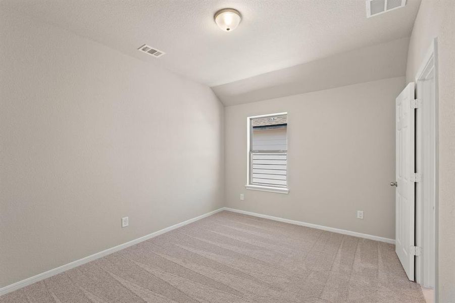 Your secondary bedroom features plush carpet, fresh paint, closet, and a large window that lets in plenty of natural lighting.