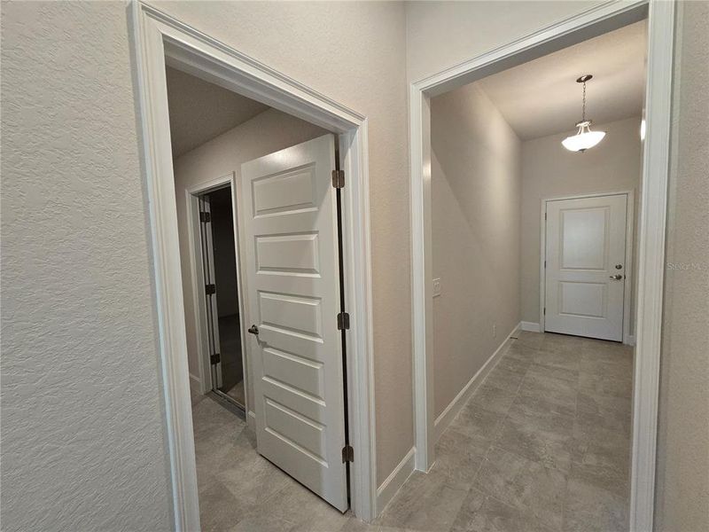 view of laundry room to garage and front door view of laundry room to garage and front door