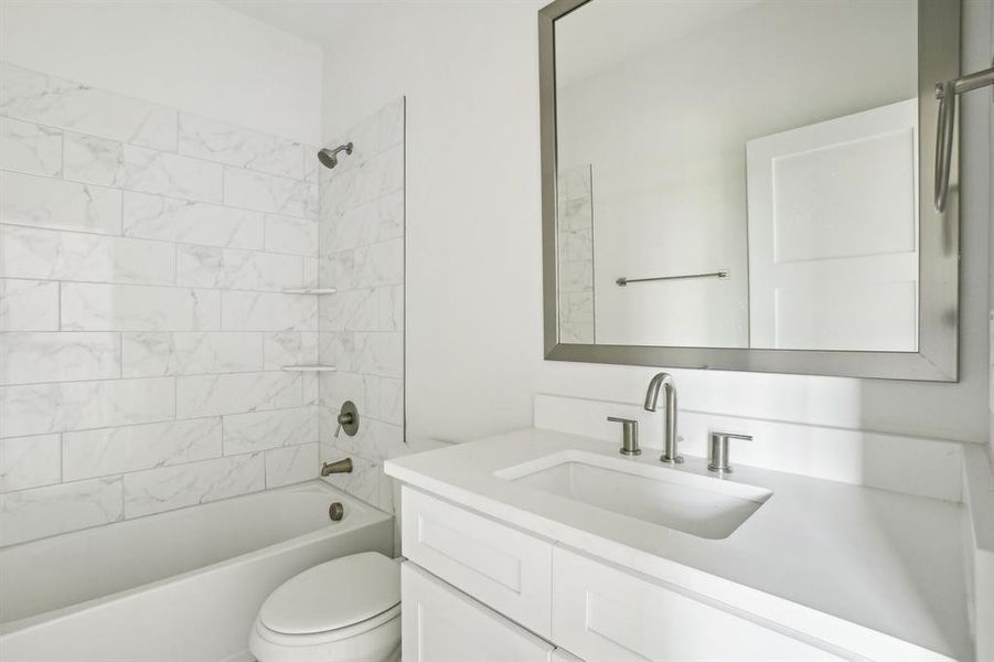 Full bathroom featuring vanity, toilet, and tub / shower combination