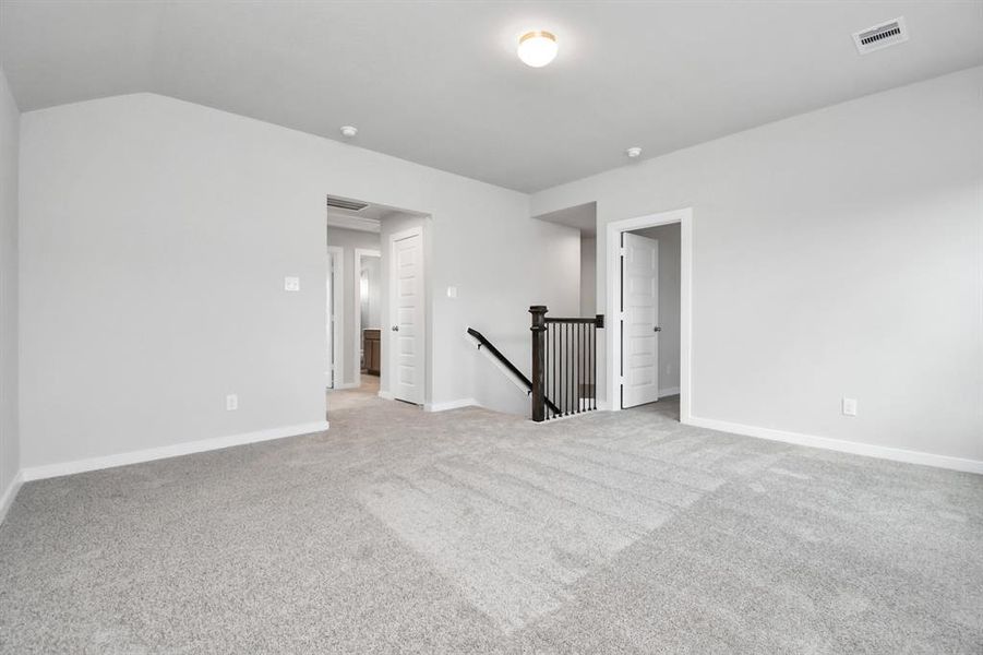 Ascend to relaxation in this fantastic game room! Ideal for both casual gatherings and adult gaming, it boasts plush carpet, lofty ceilings, custom paint, and ample windows for abundant natural light.