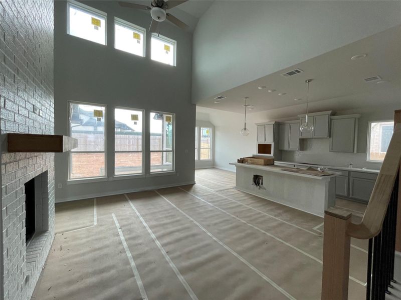Family Room with soaring ceiling & fireplace