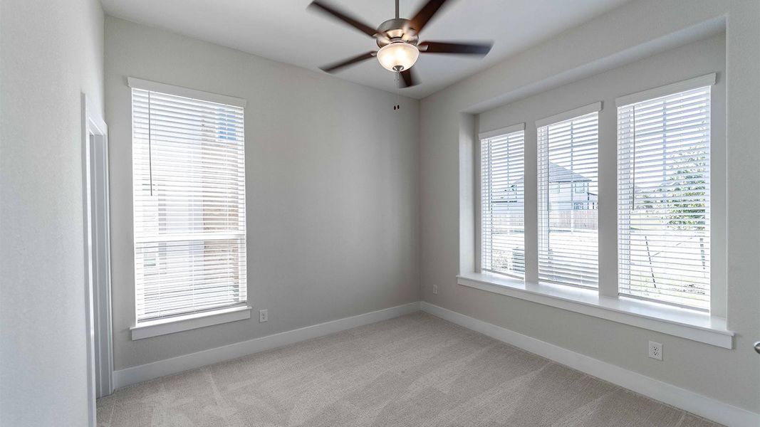 Unfurnished room featuring light carpet and a ceiling fan Unfurnished room featuring light carpet and a ceiling fan