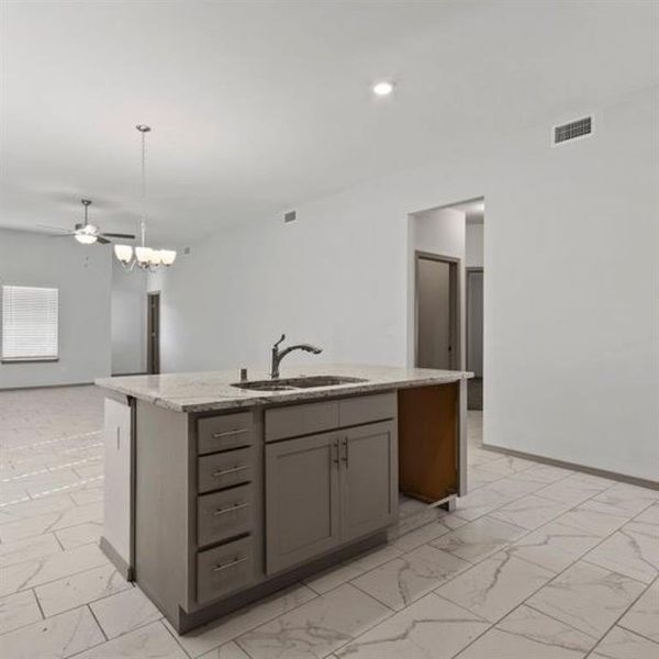 This beautifully designed kitchen is perfect for anyone who loves to cook and entertain. The large island provides plenty of counter space for food preparation and serving. **This image is from another Saratoga Home with similar floor plan - Myrtle Floorplan.**