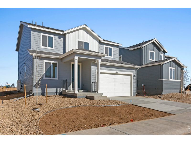 Front exterior of a new home in Trevenna, Windsor, CO, highlighting curb appeal (Image 17).