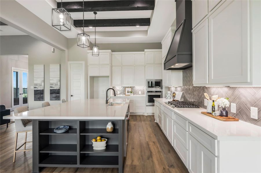 This modern kitchen features a spacious island with open shelving, and a stylish backsplash. It boasts a large gas cooktop with a contemporary hood, built-in appliances, and elegant pendant lighting, all set against beautiful flooring. This modern kitchen features a spacious island with open shelving, and a stylish backsplash. It boasts a large gas cooktop with a contemporary hood, built-in appliances, and elegant pendant lighting, all set against beautiful flooring.