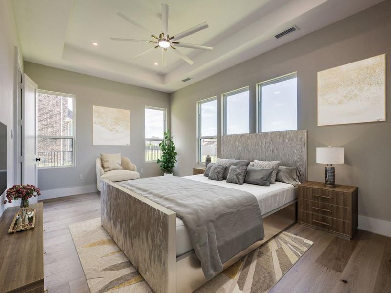 Virtual Staged Primary Bedroom featuring a tray ceiling, multiple windows, baseboard  prewired for automatic window coverings