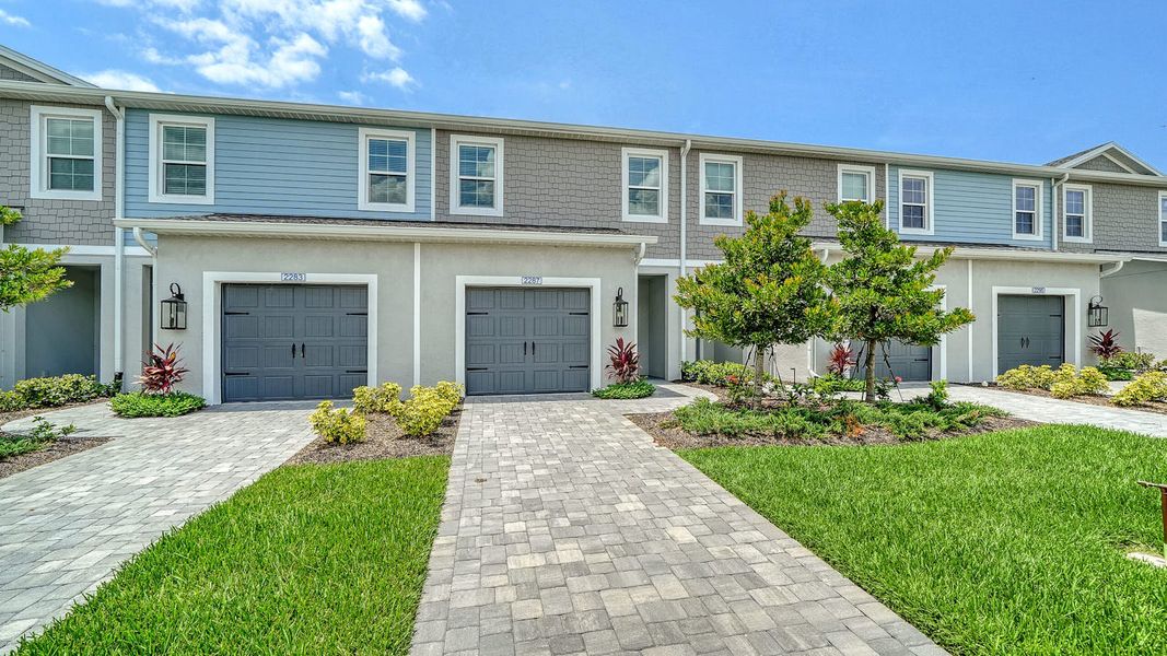 Front exterior of a new home in Palm Grove, Lakewood Ranch, FL, highlighting curb appeal (Image 1). Front exterior of a new home in Palm Grove, Lakewood Ranch, FL, highlighting curb appeal (Image 1).