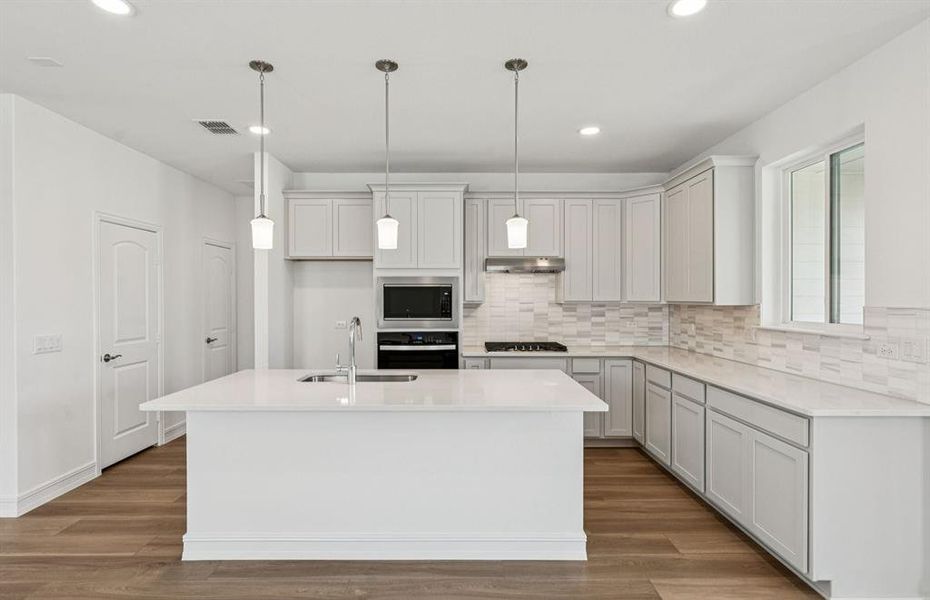 Bright kitchen with an expansive center island perfect for gatherings Bright kitchen with an expansive center island perfect for gatherings