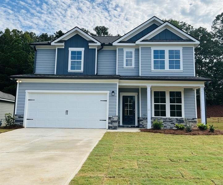 Front exterior of a new home in Sutton's Landing, Statham, GA, highlighting curb appeal (Image 1).