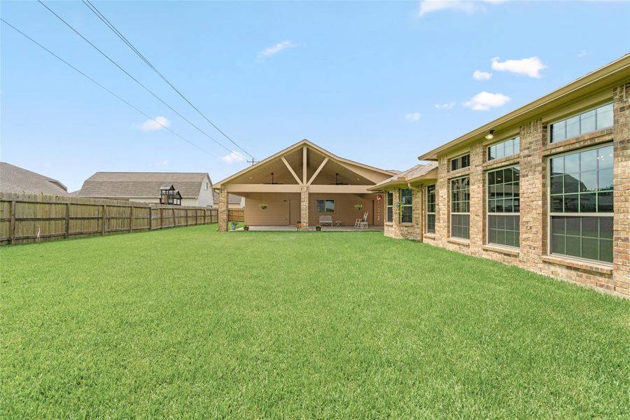 Fully fenced for privacy, the yard creates a secure and serene retreat for kids, pets, and guests alike. Fully fenced for privacy, the yard creates a secure and serene retreat for kids, pets, and guests alike.