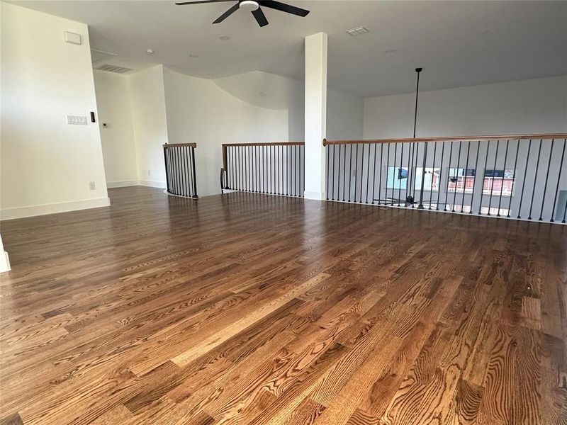 Spare room with hardwood / wood-style flooring and ceiling fan