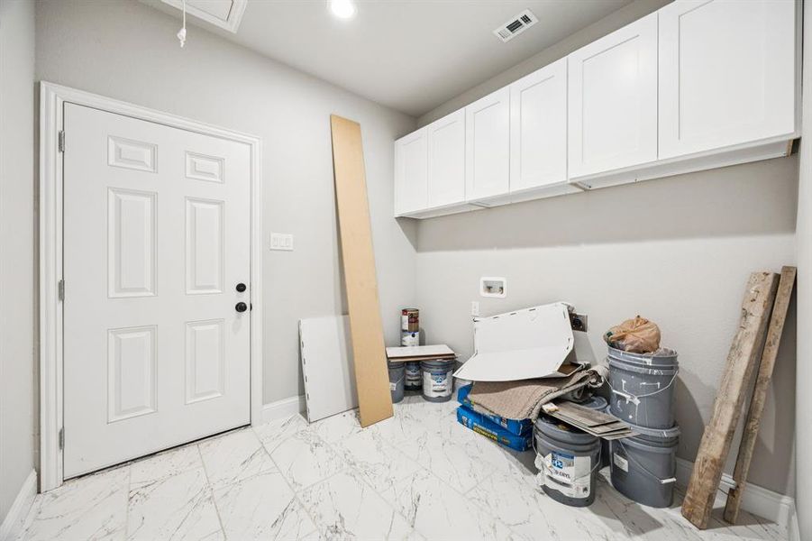 Laundry area with light marble finish floors, hookup for a washing machine, attic access, recessed lighting, and cabinet space