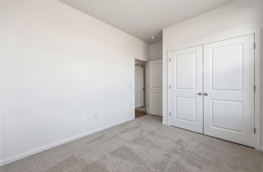 Unfurnished bedroom featuring carpet floors and a closet