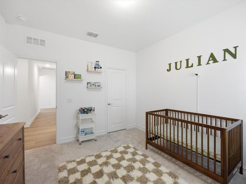 Guest bedroom view of single story three bedroom home with an office and a formal dining room