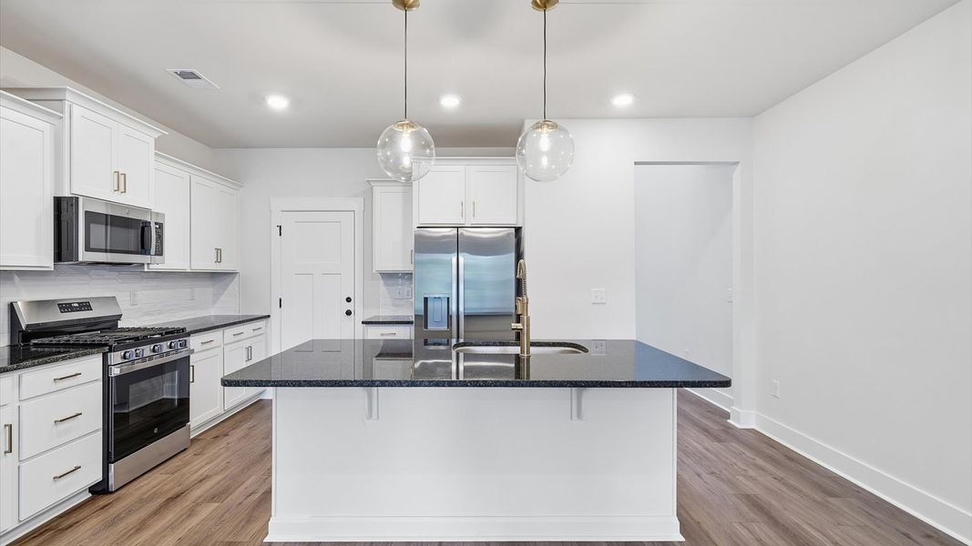 Exceptional kitchen featuring a spacious island, eye-catching pendant lights, and modern finishes near Lake Hartwell Exceptional kitchen featuring a spacious island, eye-catching pendant lights, and modern finishes near Lake Hartwell