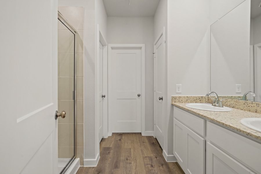 A bathroom with white cabinets. A bathroom with white cabinets.